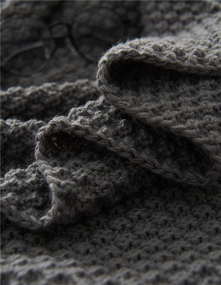 Couverture en maille avec pompons et motifs en relief