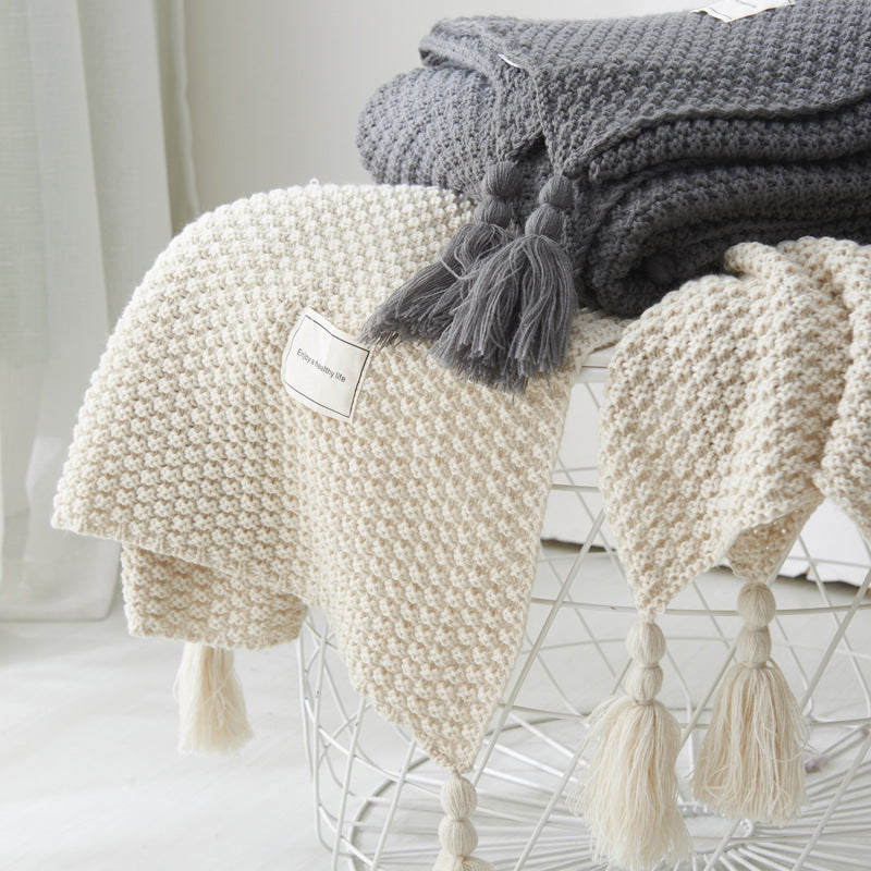 Couverture en maille avec pompons et motifs en relief