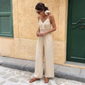 Combinaison pantalon long en dentelle unie douce au toucher, ornée de pompons et de bretelles côtelées